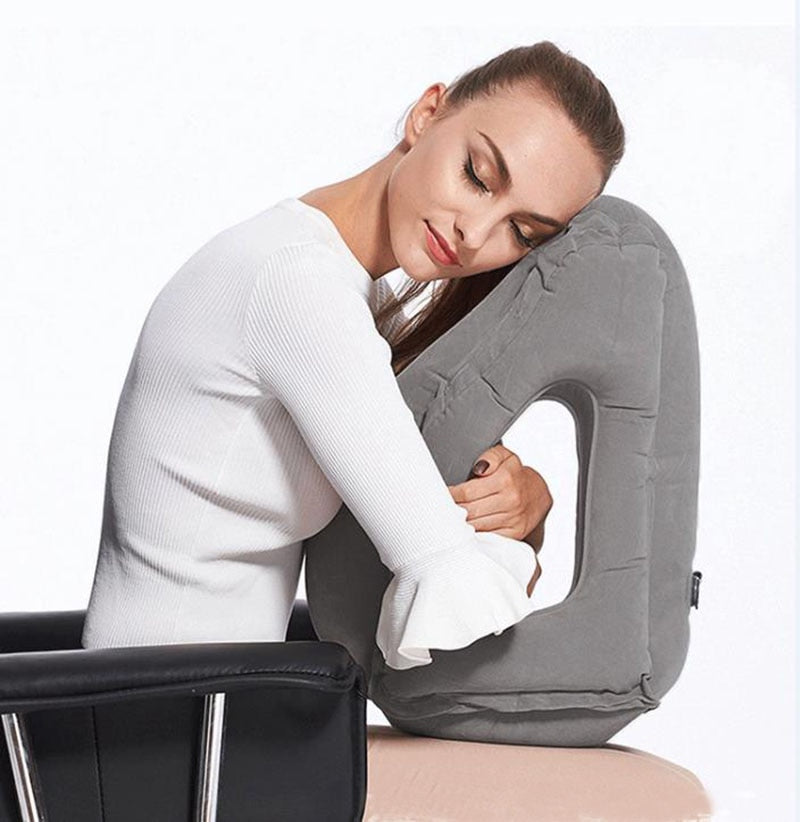 Image of woman sitting down and using the Zen Air Inflatable Pillow.