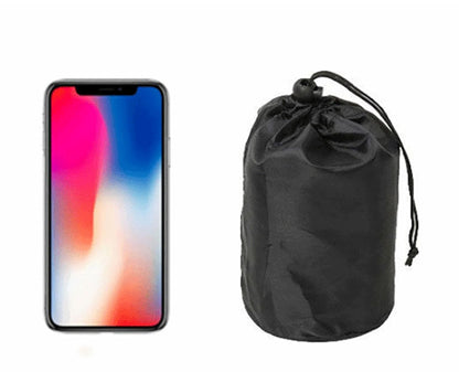 Size comparison of the Zen Air Inflatable Pillow pouch next to a phone.